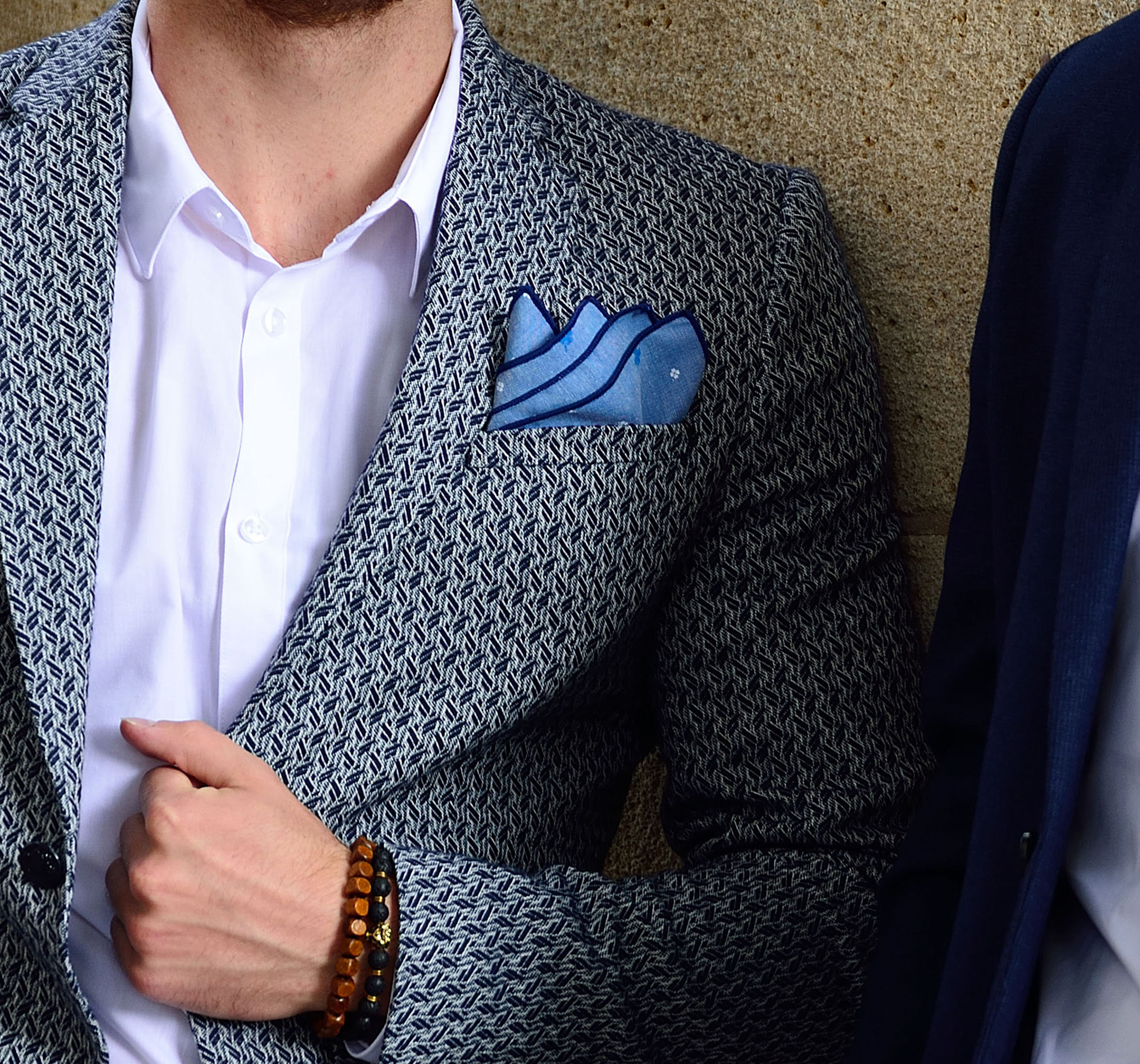 Monumental building with two men in front and gorgeous pocket squares by di Venisco.